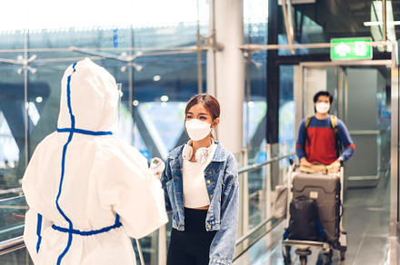 Doctor woman use infrared forehead thermometer for check body te, a Person Photo by Art_Photo