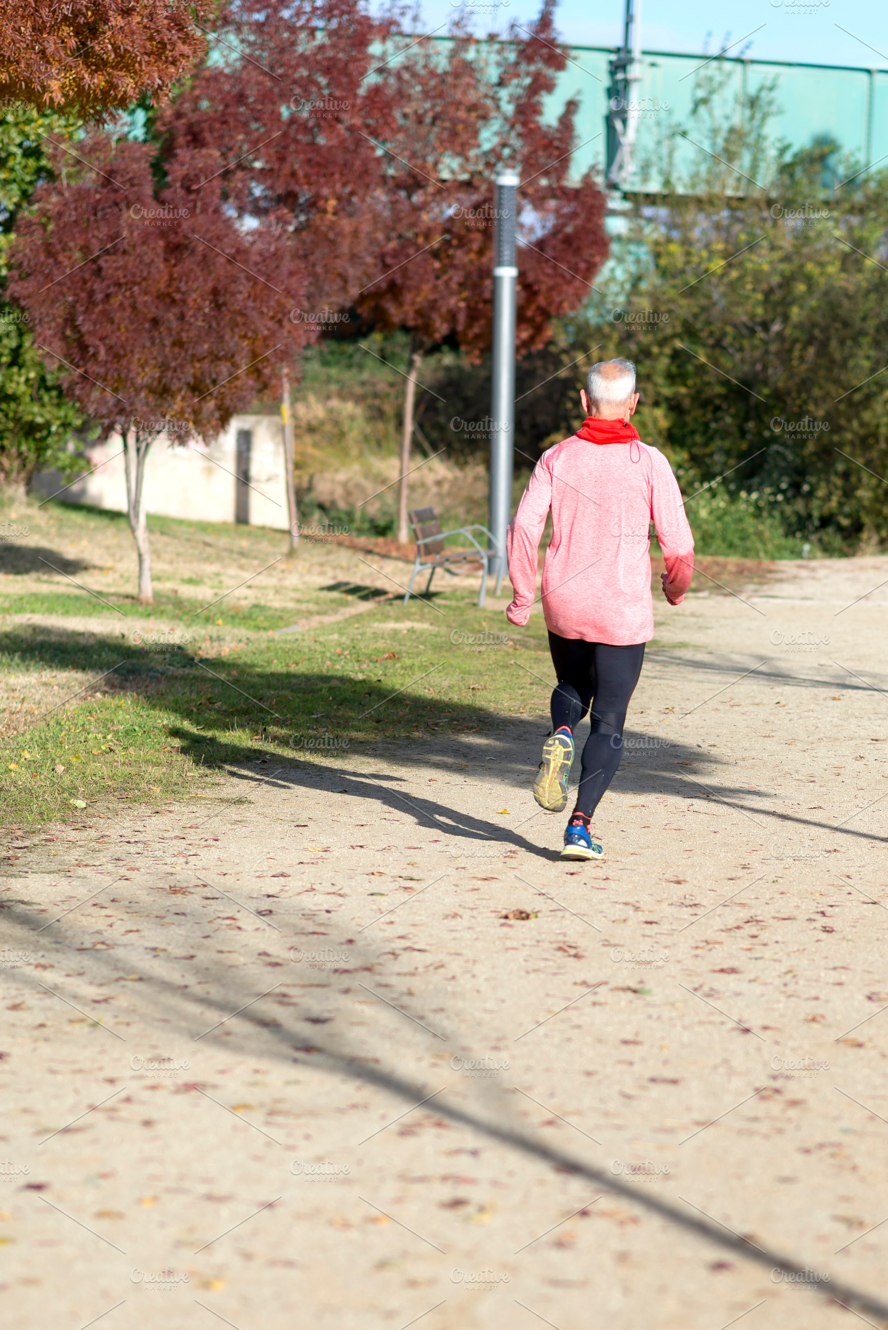 Senior man jogging in the park on a sunny day, a Sports & Recreation Photo by RF Images