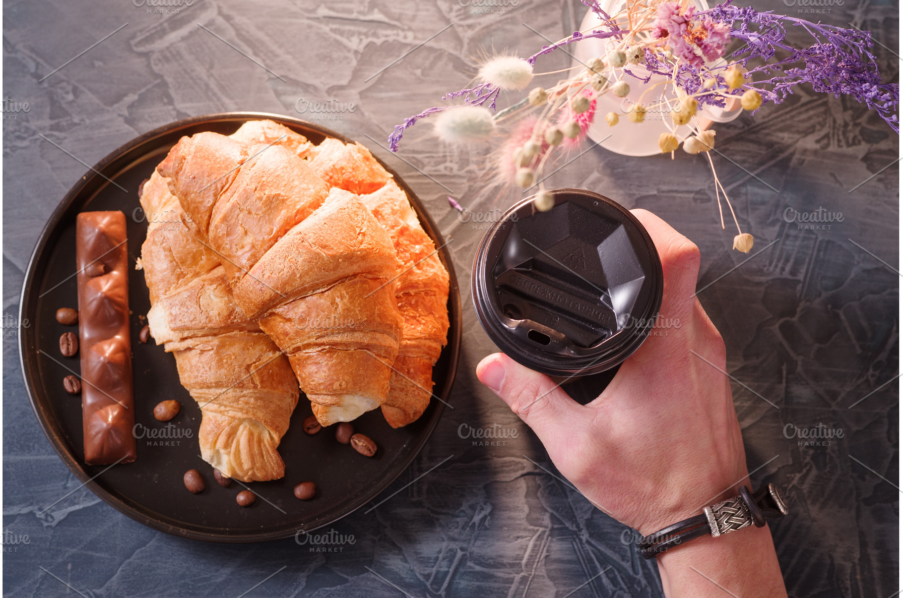 Guest holding coffee and croissants, a Food & Drink Photo by Stockphoto by vzwer