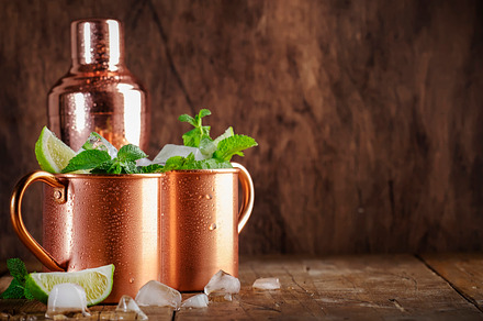 Moscow mule cocktails in copper mug with lime, ice, ginger beer,, a Food & Drink Photo by 5PH