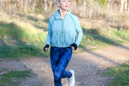Beautiful athletic woman running in forest, a Sports & Recreation Photo by RF Images