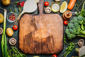 Vegetables around cutting board 