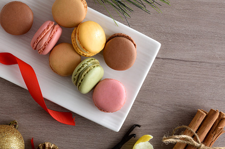 Detail of assorted macaroons on wooden table with Christmas deco, a Food & Drink Photo by Davizro's Market