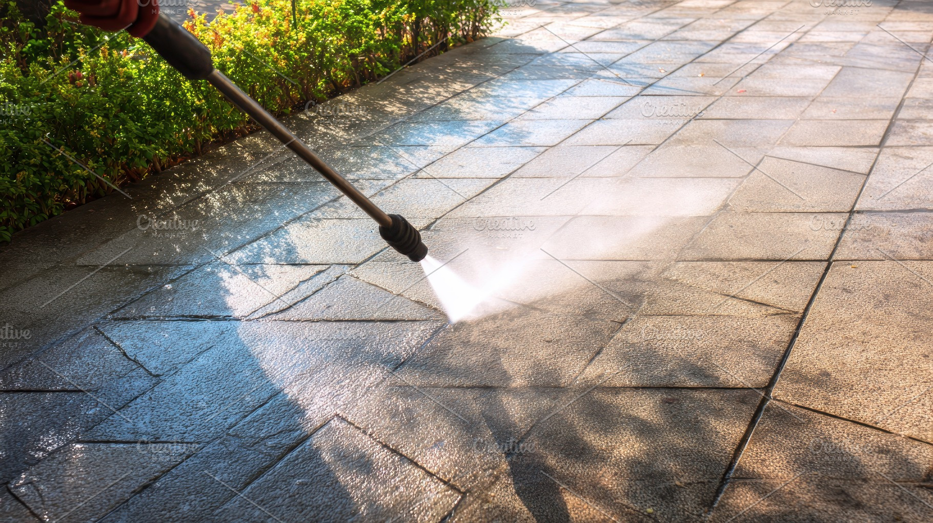 Power washing a patio surface, a Photo by Pavel_design