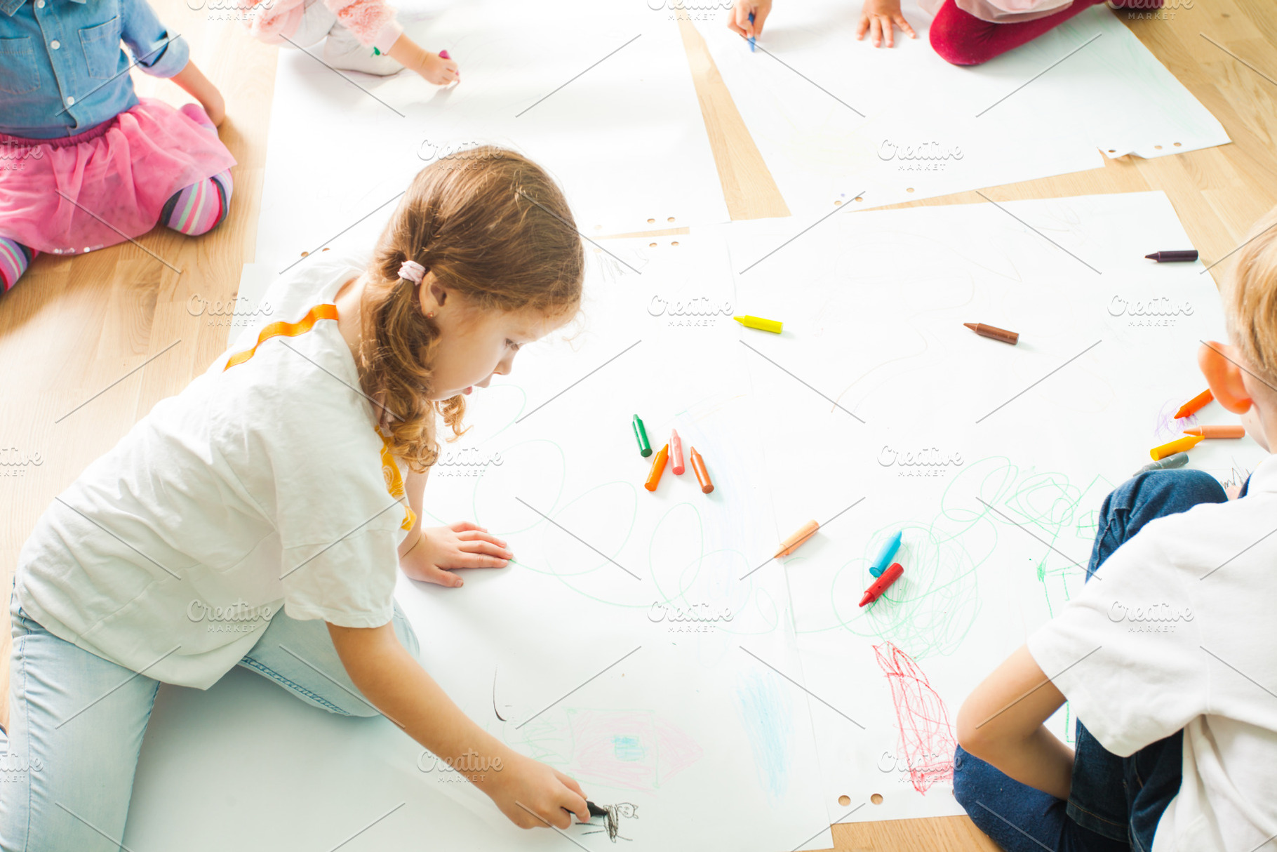 Children drawing with crayons on a, a School & Education Photo by oksix