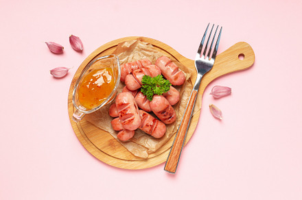 Concept of tasty food, grilled mini sausage, top view, a Food & Drink Photo by AtlasStudio PRO