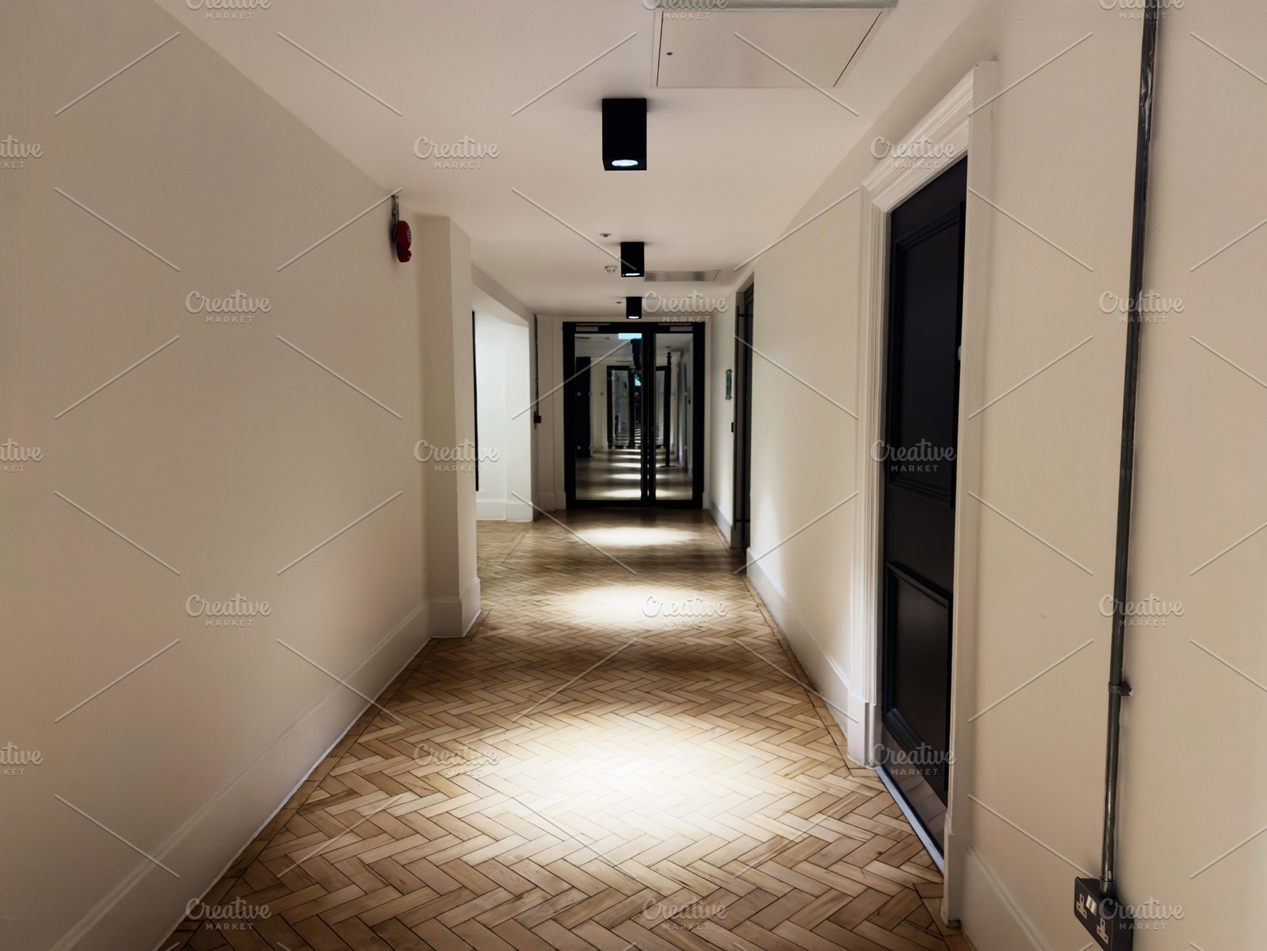 Quiet hotel hallway with warm lighting and mirrored end stretching into the dis, a Photo by AS photostudio
