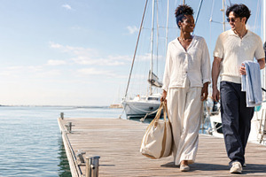Couple walking on marina dock with s, a Photo by Dvoevnore photos