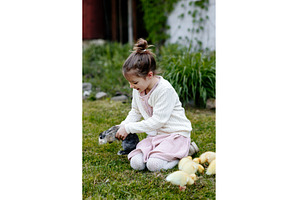 Smiling child playing with baby, an Animal Photo by HalfPoint