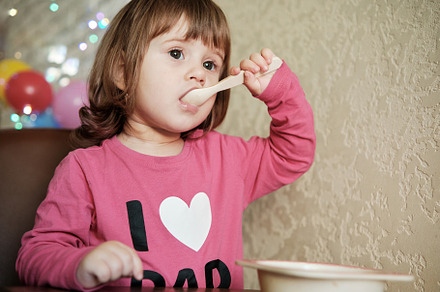 Cute Little Girl 2 Years alone eats porridge with a spoon., a Person Photo by Rohan Photography