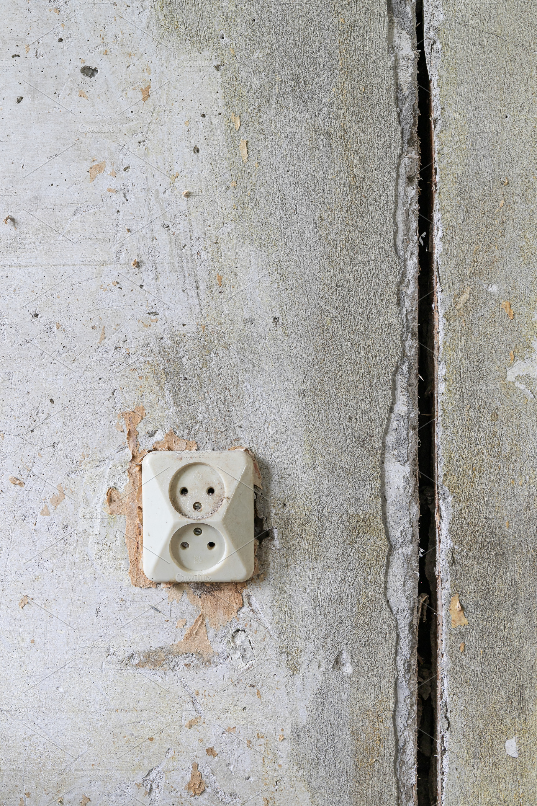Old electrical outlet on a wall, an Architecture Photo by Edalin's Store