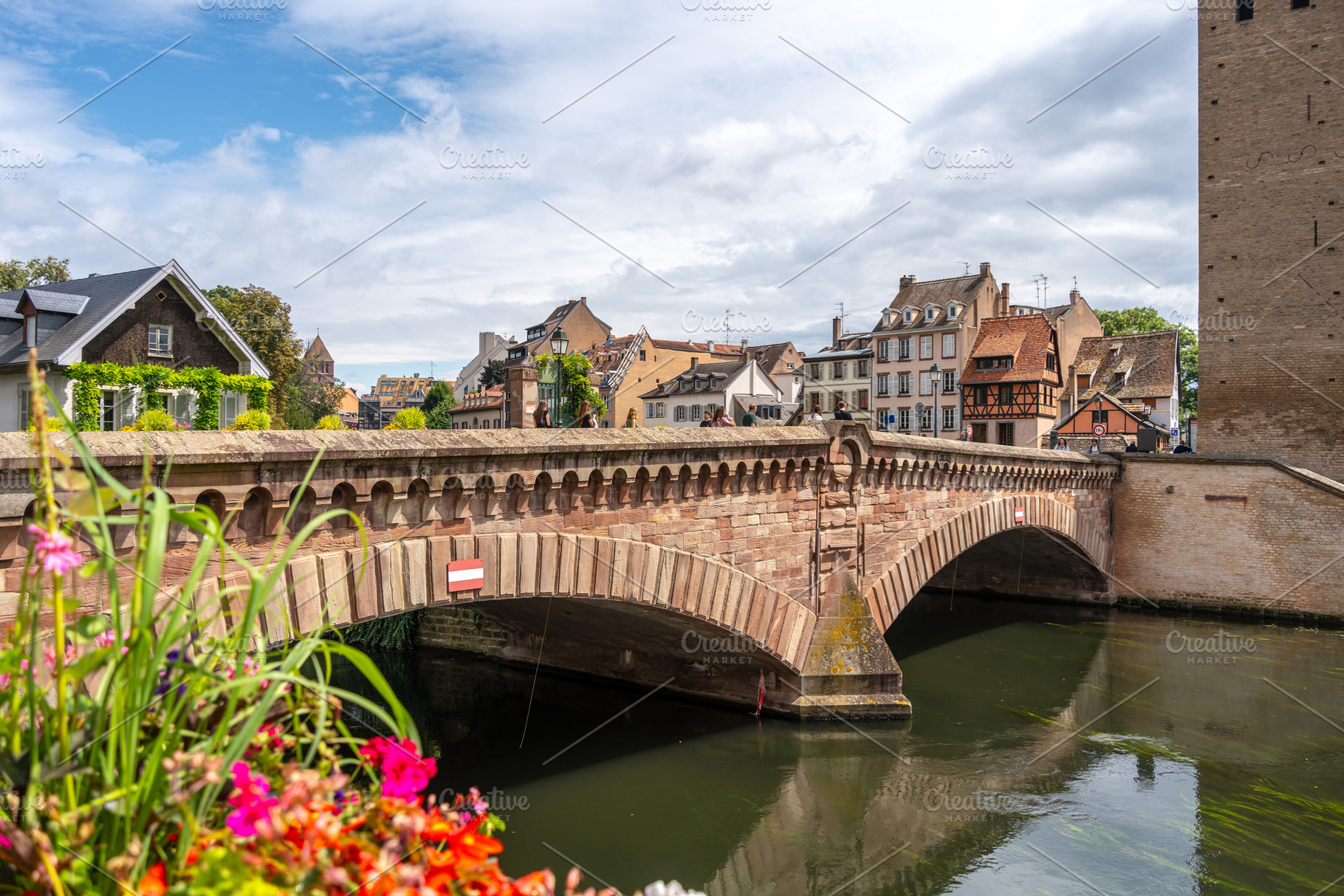 Stone bridge and traditional houses in Strasbourg, France, an Architecture Photo by GoodGoods
