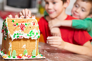 children decorate gingerbread house