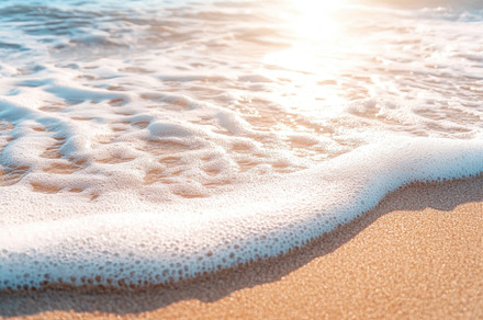 Frothy ocean waves gently lapping at, a Photo by Iftikhar Alam