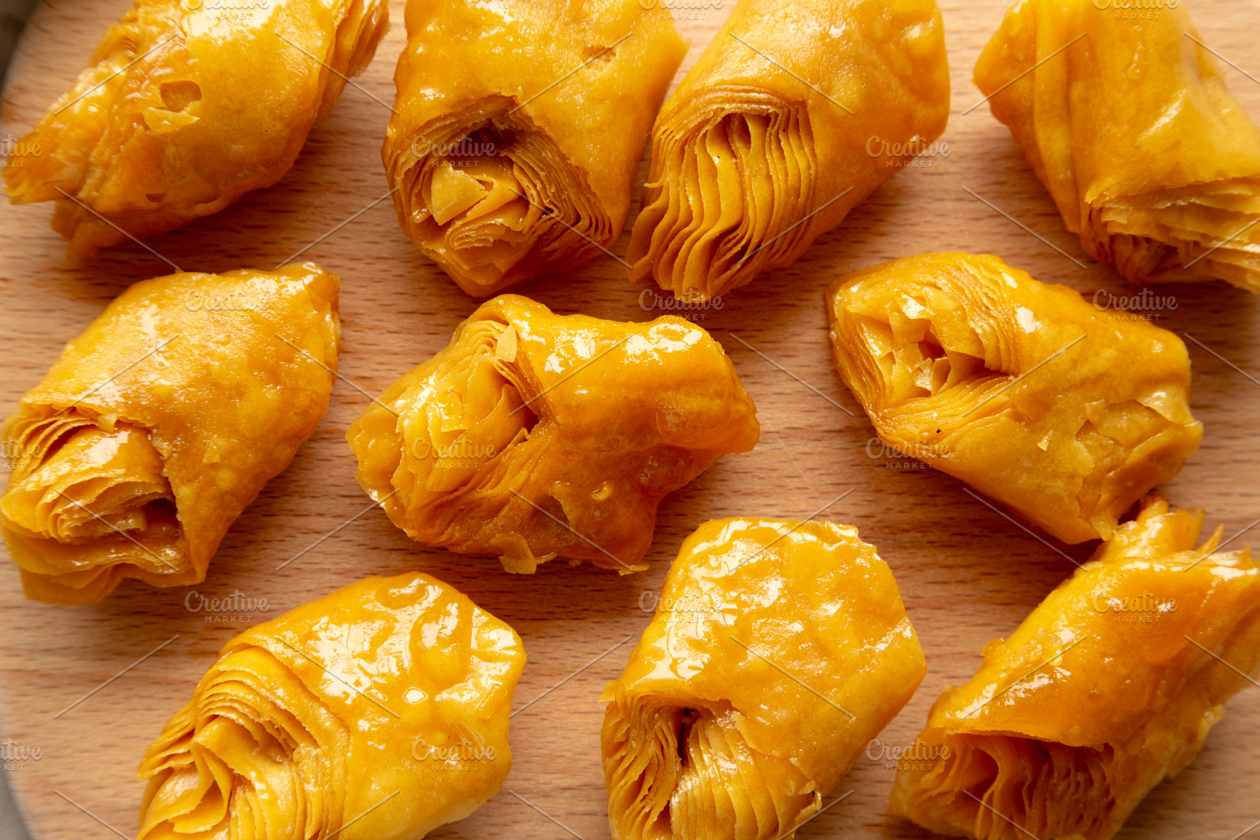 Sweet Homemade Turkish Baklava with Honey on a Wooden Board, top, a Food & Drink Photo by LiudmylaChuhunova