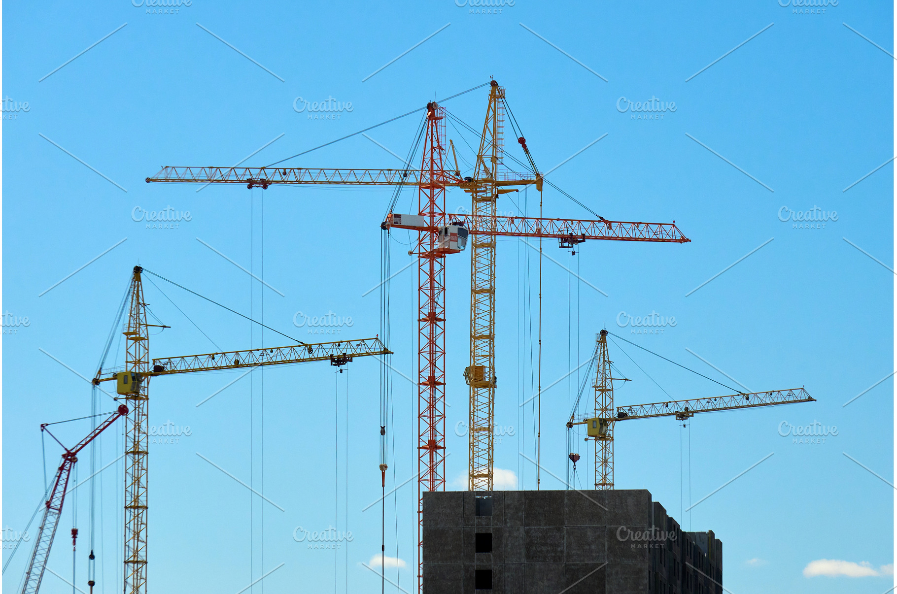 Cranes are lifting materials at a, an Industrial Photo by darksoul72