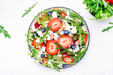 Strawberry and herbs healthy salad with arugula, blueberries, so, a Food & Drink Photo by 5PH