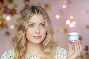 Blonde woman presenting a blank white cosmetic jar for beauty an, a Person Photo by Studio ANNA