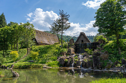 Traditional houses and waterfall pond in Shirakawa-go, Japan