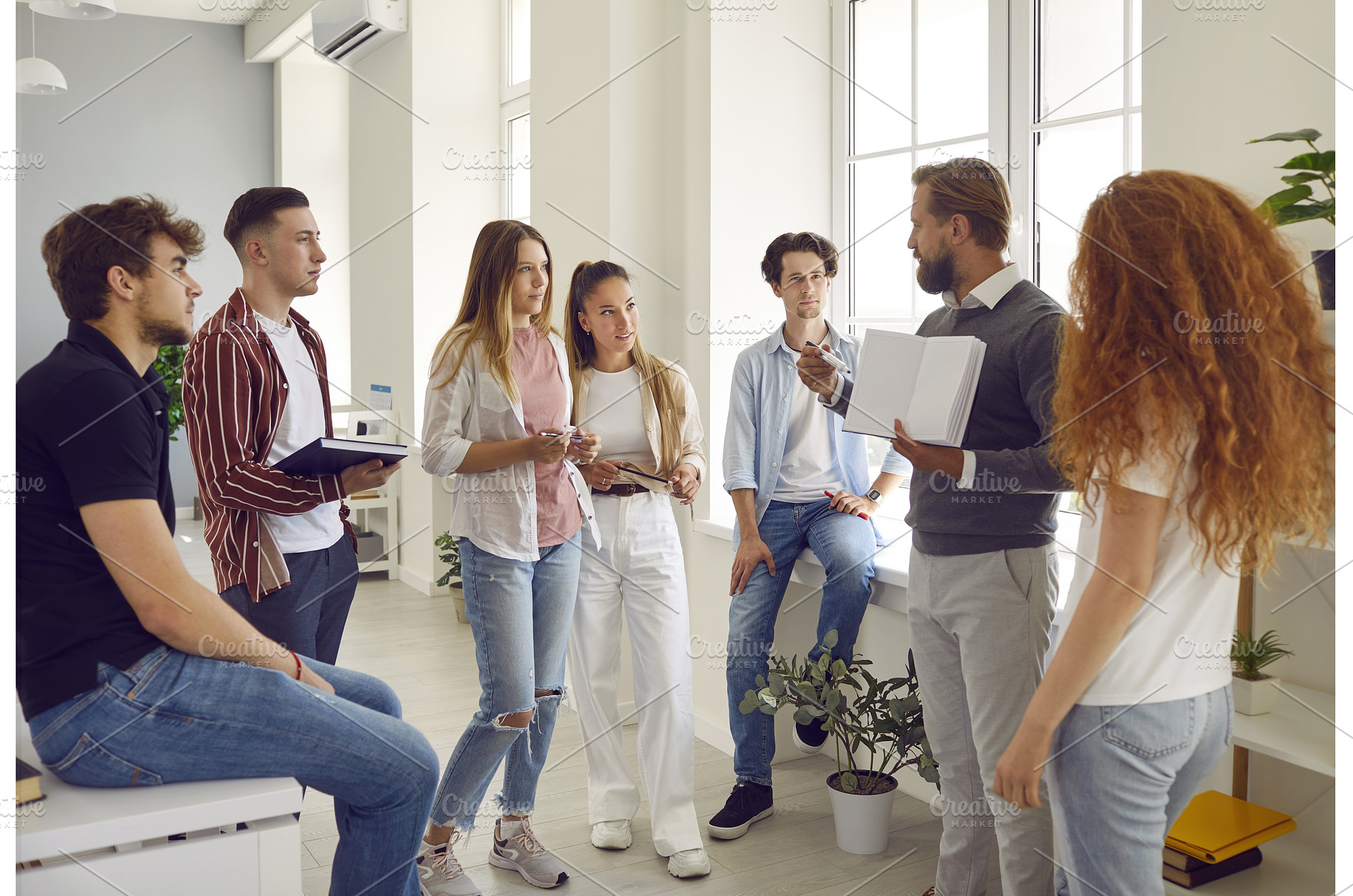 Group of students listening a, a Person Photo by StudioRomantic