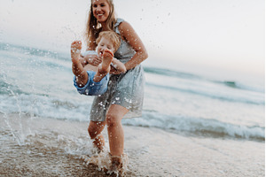 Mother playing with little son in, a Person Photo by HalfPoint