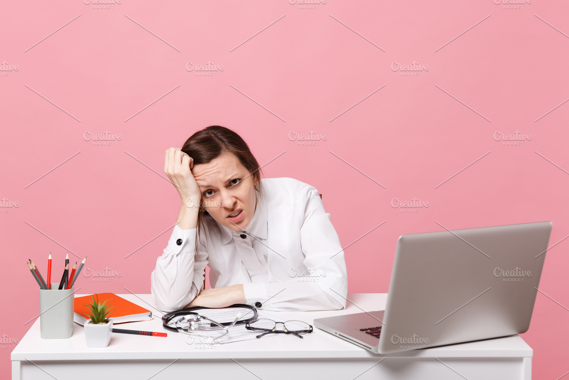 Tired sad female doctor sits at desk containing medic, office, and consultant, a Person Photo by ViDi Studio