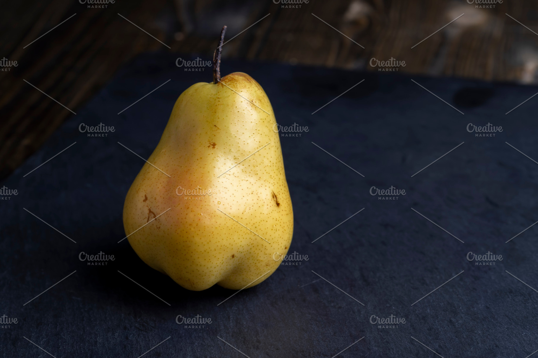ripe green and yellow pear on a board, a Photo by MyPhotos