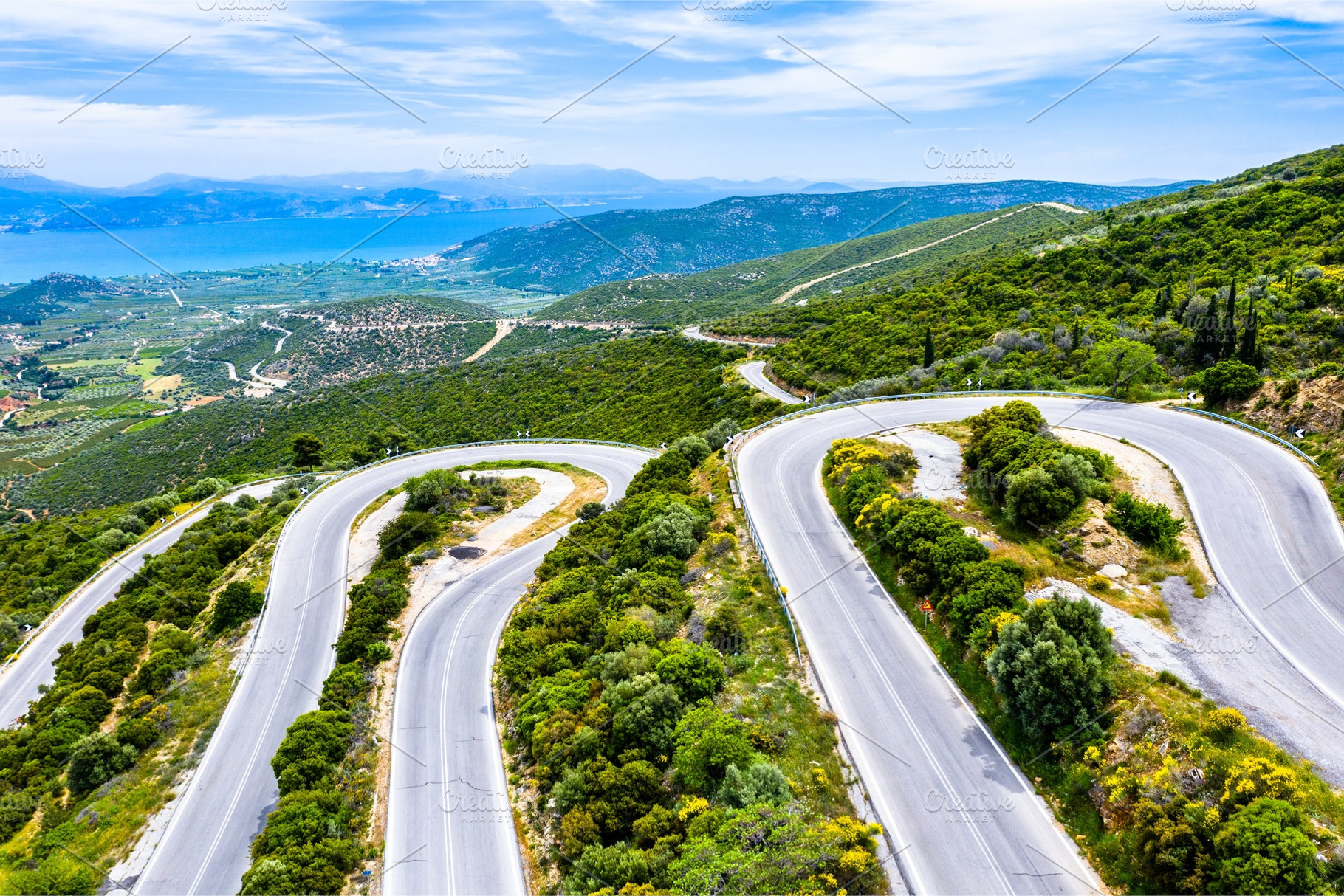 Winding road in the mountains of stock photo containing mountain and road, a Transportation Photo by Leonid Andronov