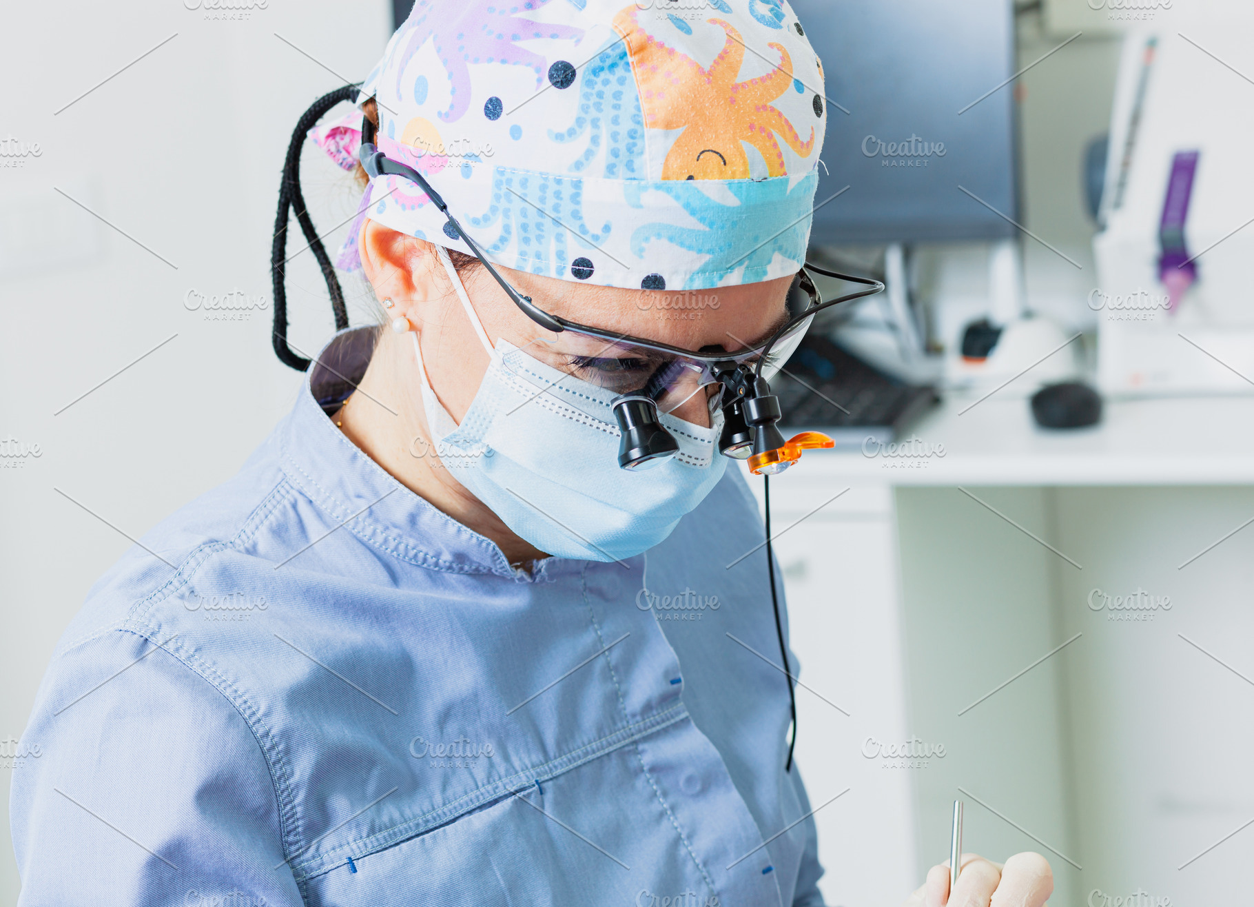 Dentist wearing magnifying glasses performing dental checkup, a Health & Medical Photo by Antonio Gravante Market