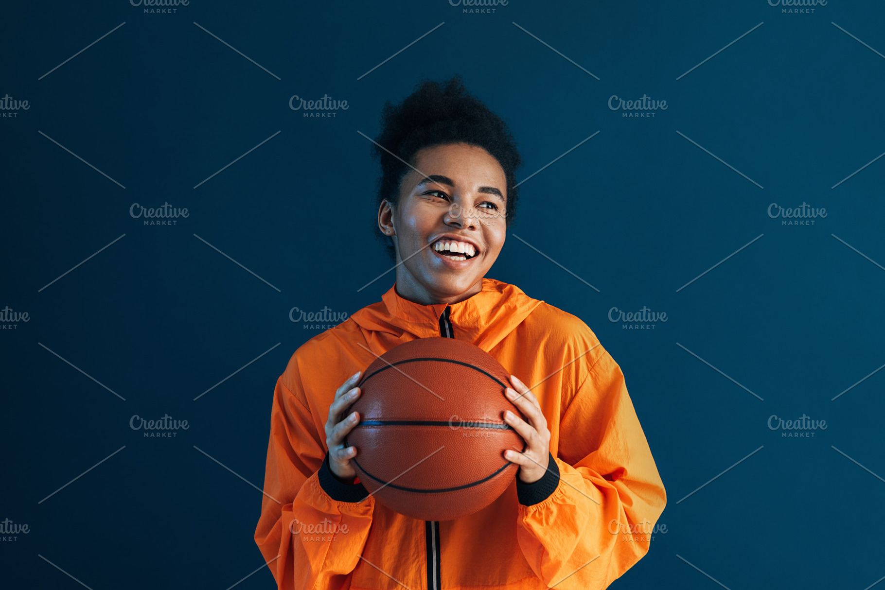 Portrait of a happy woman in orange, a Sports & Recreation Photo by Artem Varnitsin