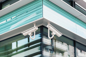 Cctv security cameras on modern wall, a Technology Photo by BOOCYS