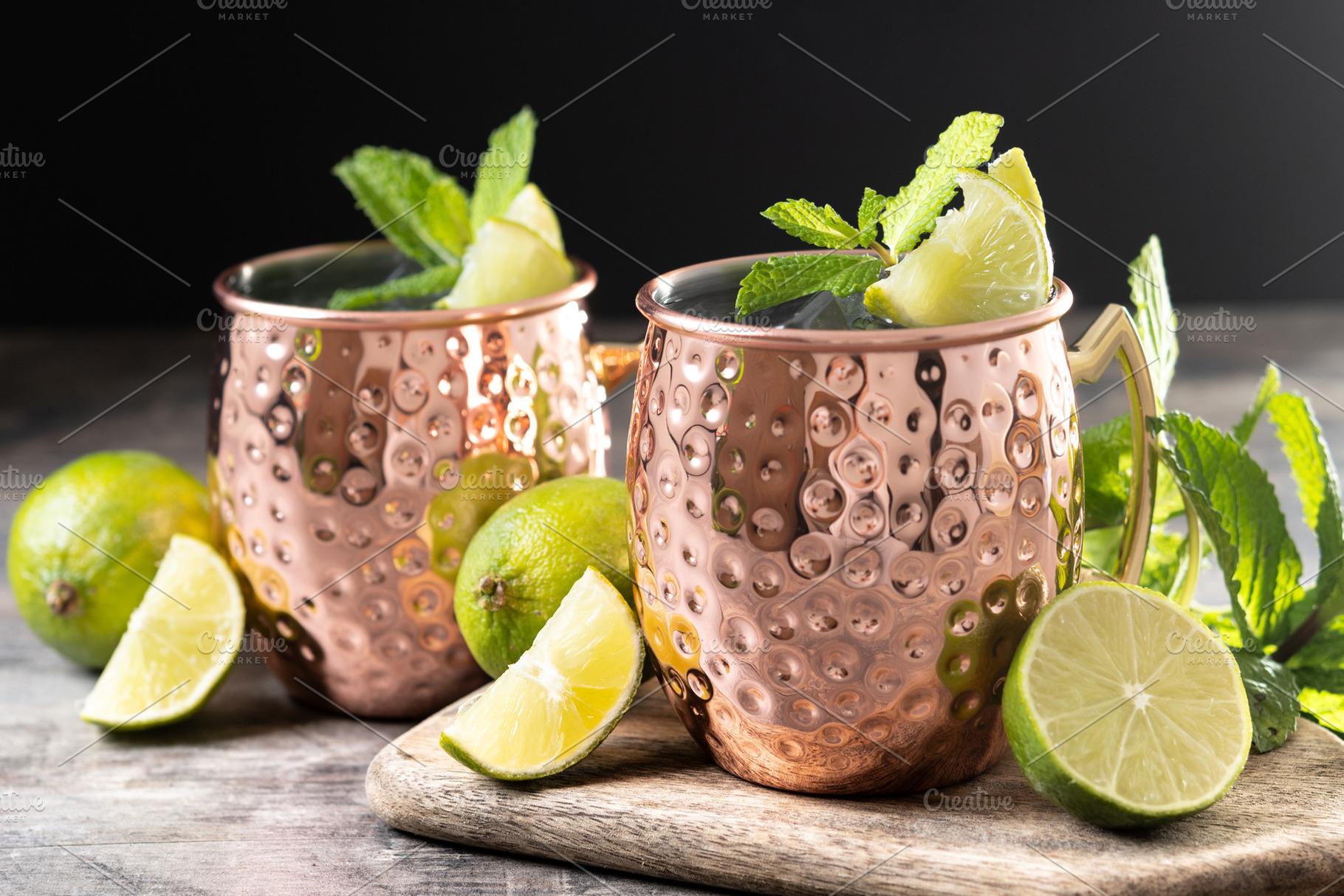 Moscow mule cocktail served with ice and lime slice on wooden table., a Food & Drink Photo by etorres69