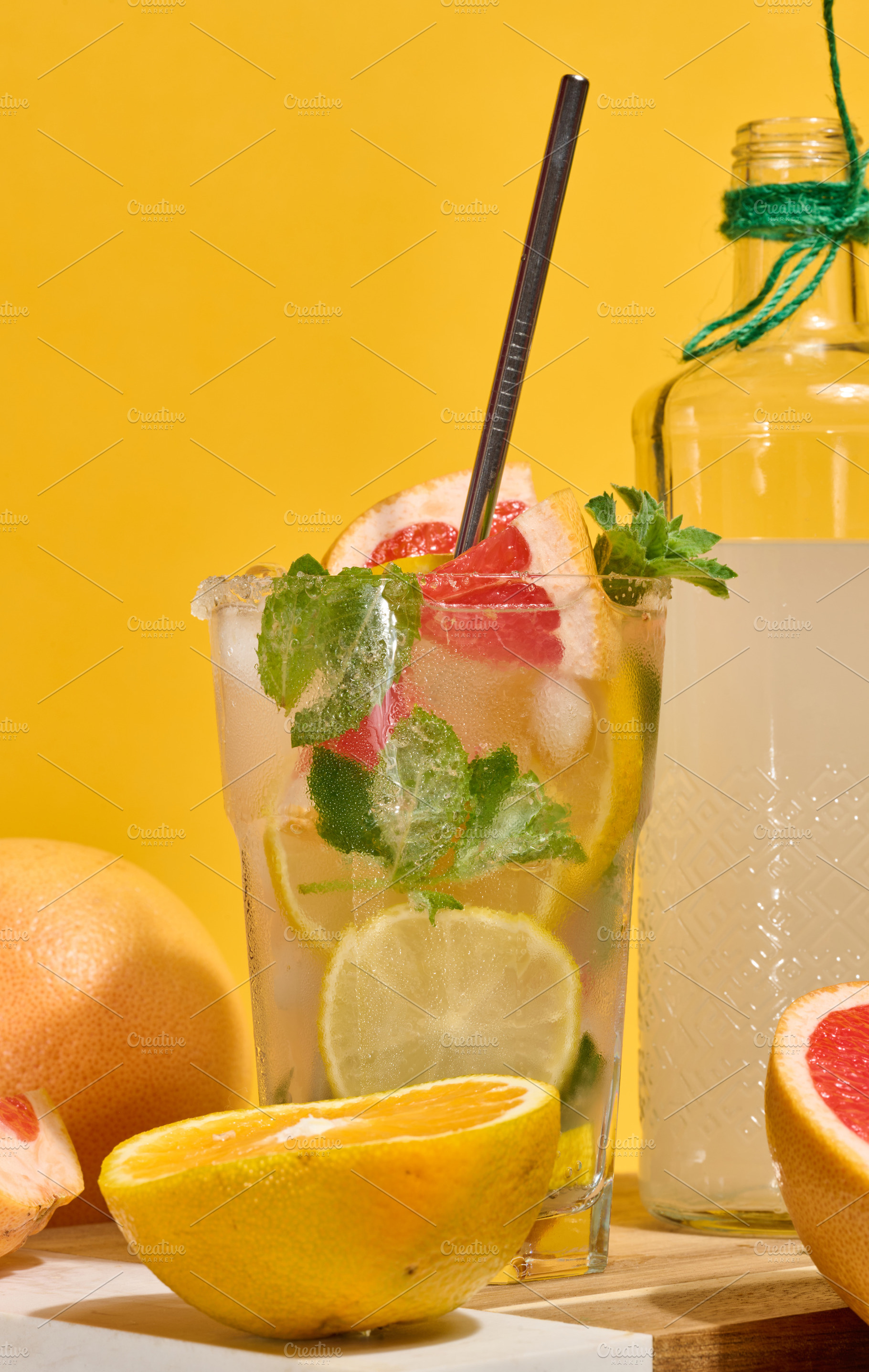 Glass with cold cocktail, citrus pieces inside, homemade drink, a Food & Drink Photo by ndanko