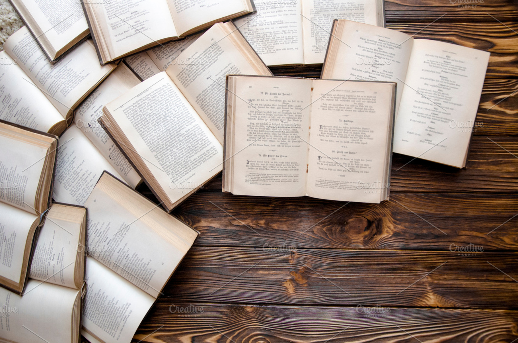 Opened books lying on the wooden table with pocketbook study stock photo, a School & Education Photo by velychko.ua