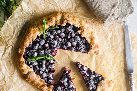 Homemade blackcurrant galette on old concrete background., a Food & Drink Photo by vimart