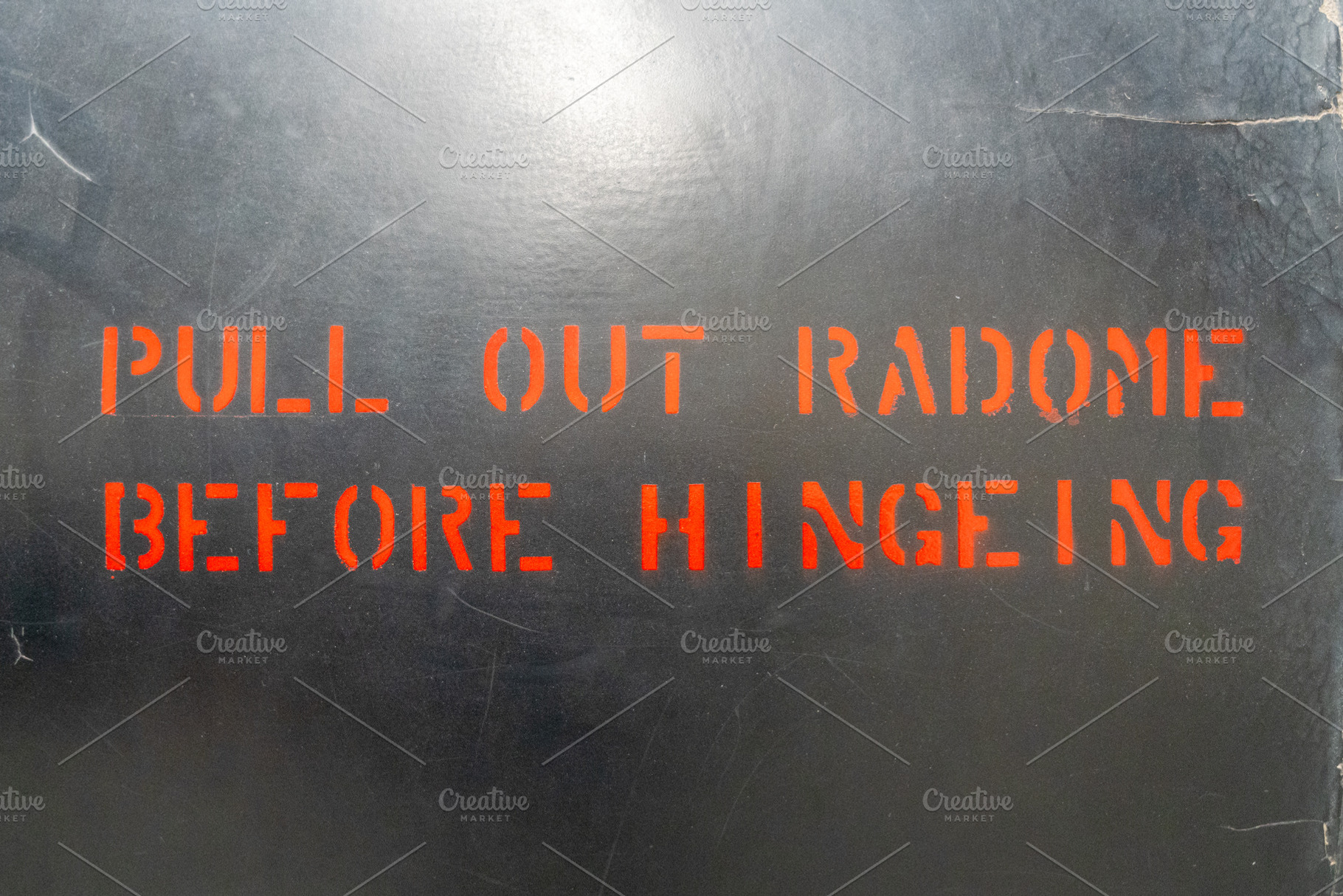 Aircraft fuselage warning message with red stencil lettering, a Background Photo by GoodGoods