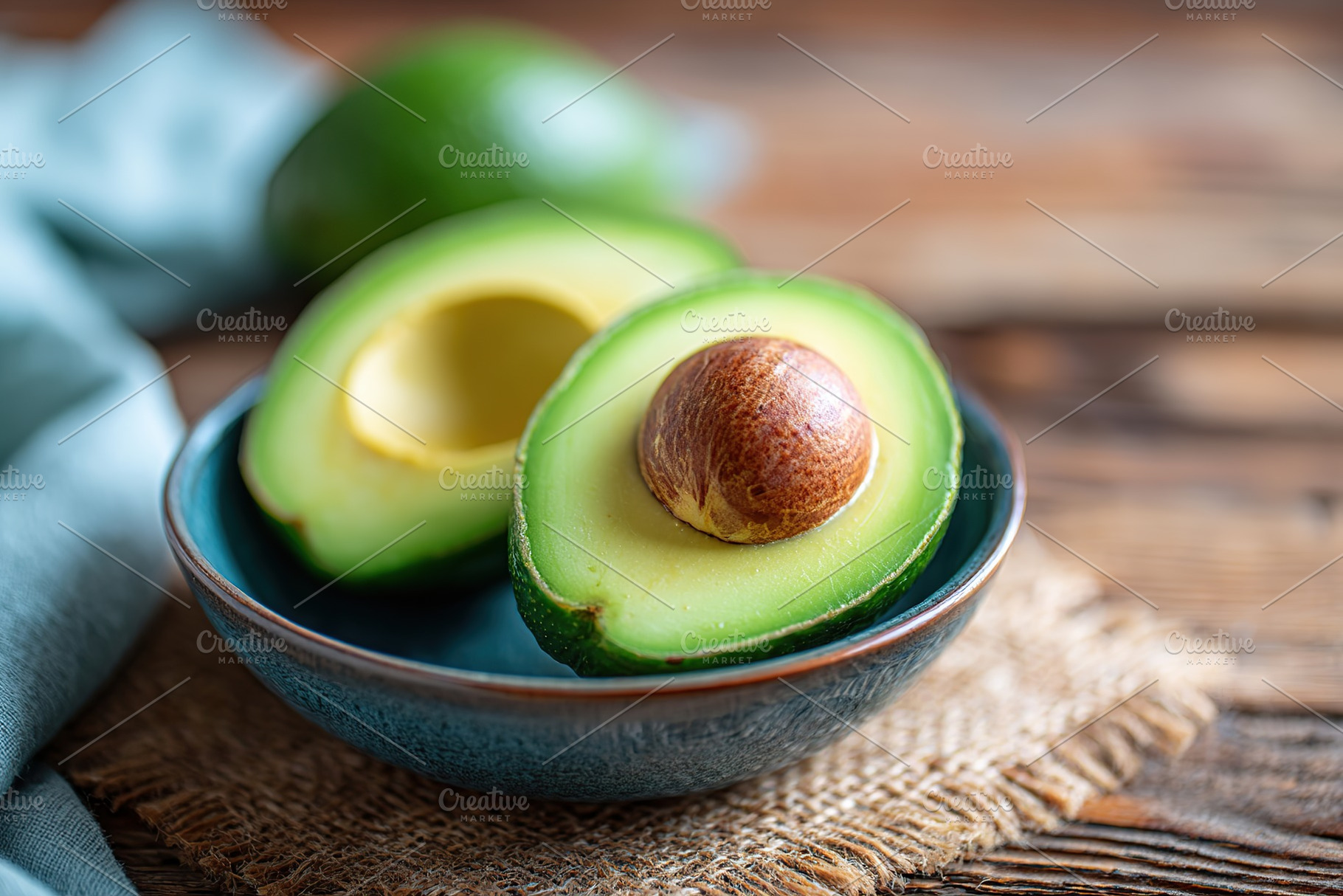 Ripe avocado halves showcasing vibrant green pulp on a rustic wooden table, a Food & Drink Photo by AlyaAnd