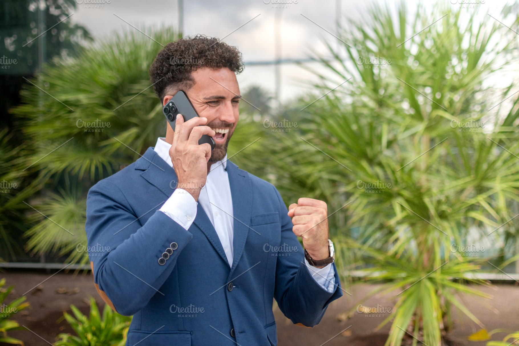 Excited businessman celebrating good news during phone call, a Business Photo by etorres69