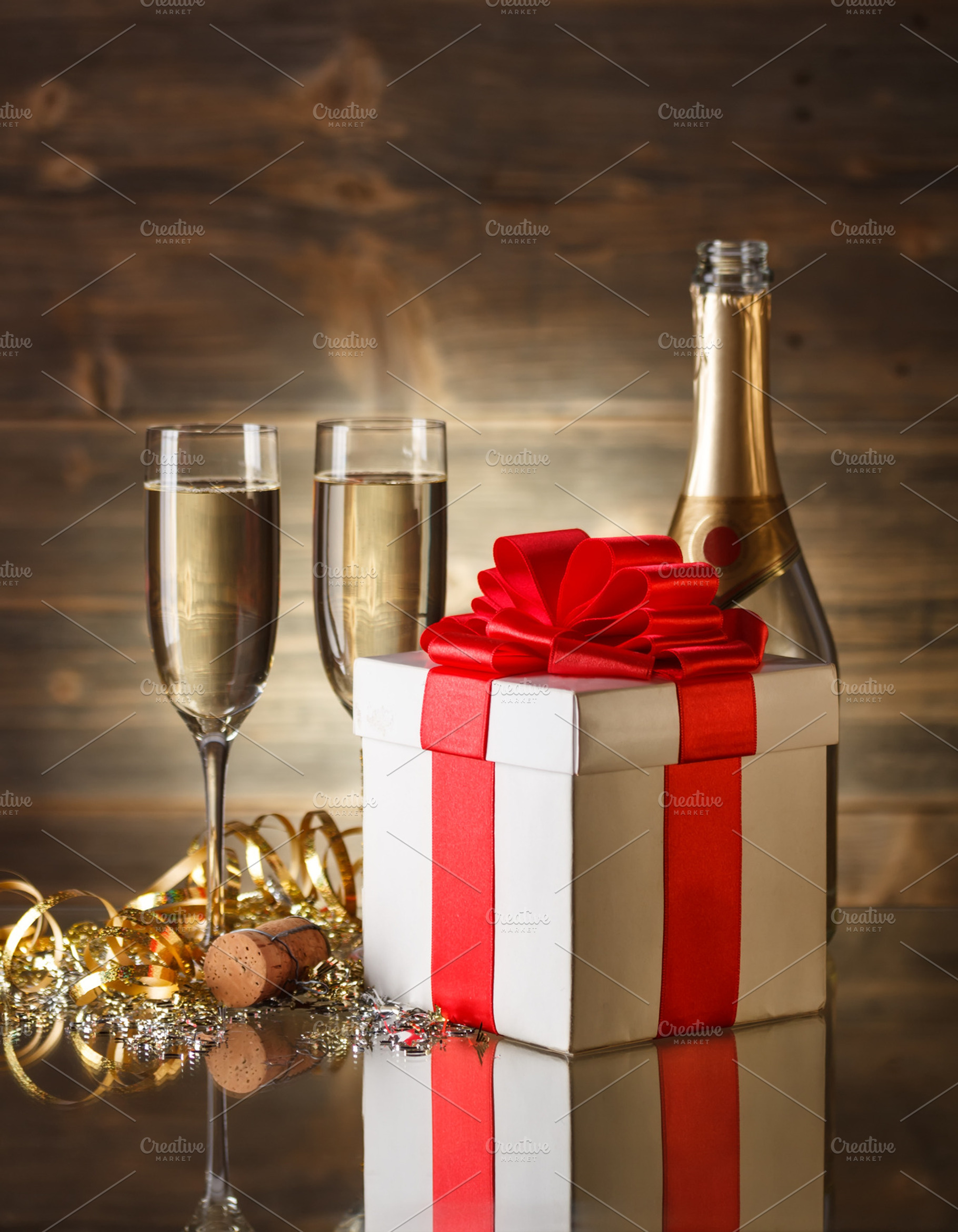Glasses of champagne featuring box, gift, and ribbon