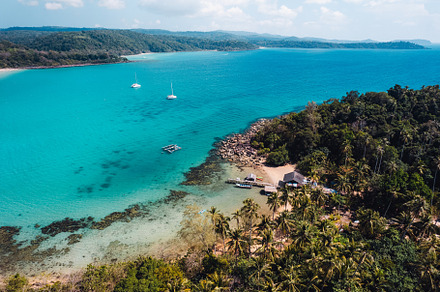 Tropical island from above and clear blue sea, a Nature Photo by Art Rachen