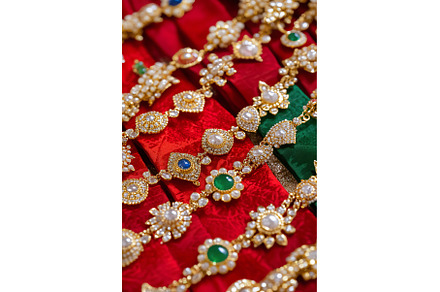 Exquisite gold jewelry on vibrant, a Background Photo by Lermont51