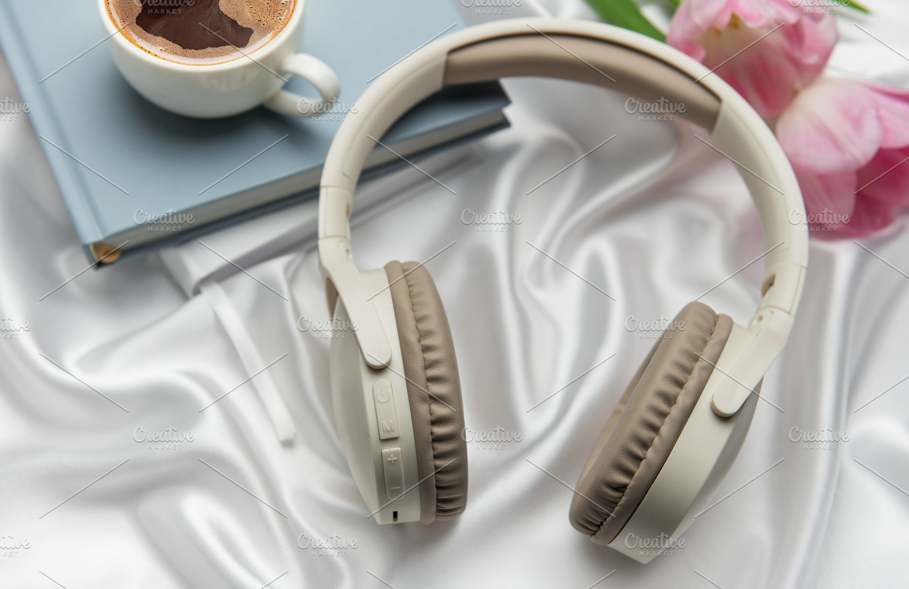Wireless headphones, coffee, book, and pink tulips resting on wh, a Technology Photo by Olena Rudo