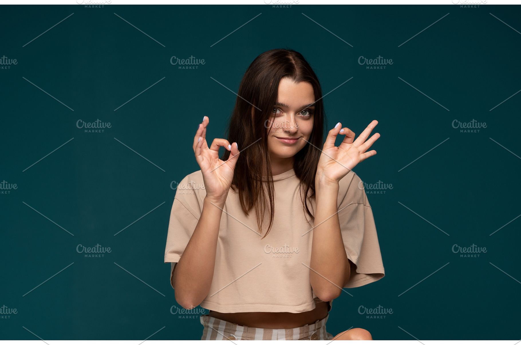Happy woman making an ok sign with, a Person Photo by volodymyrshtun13795