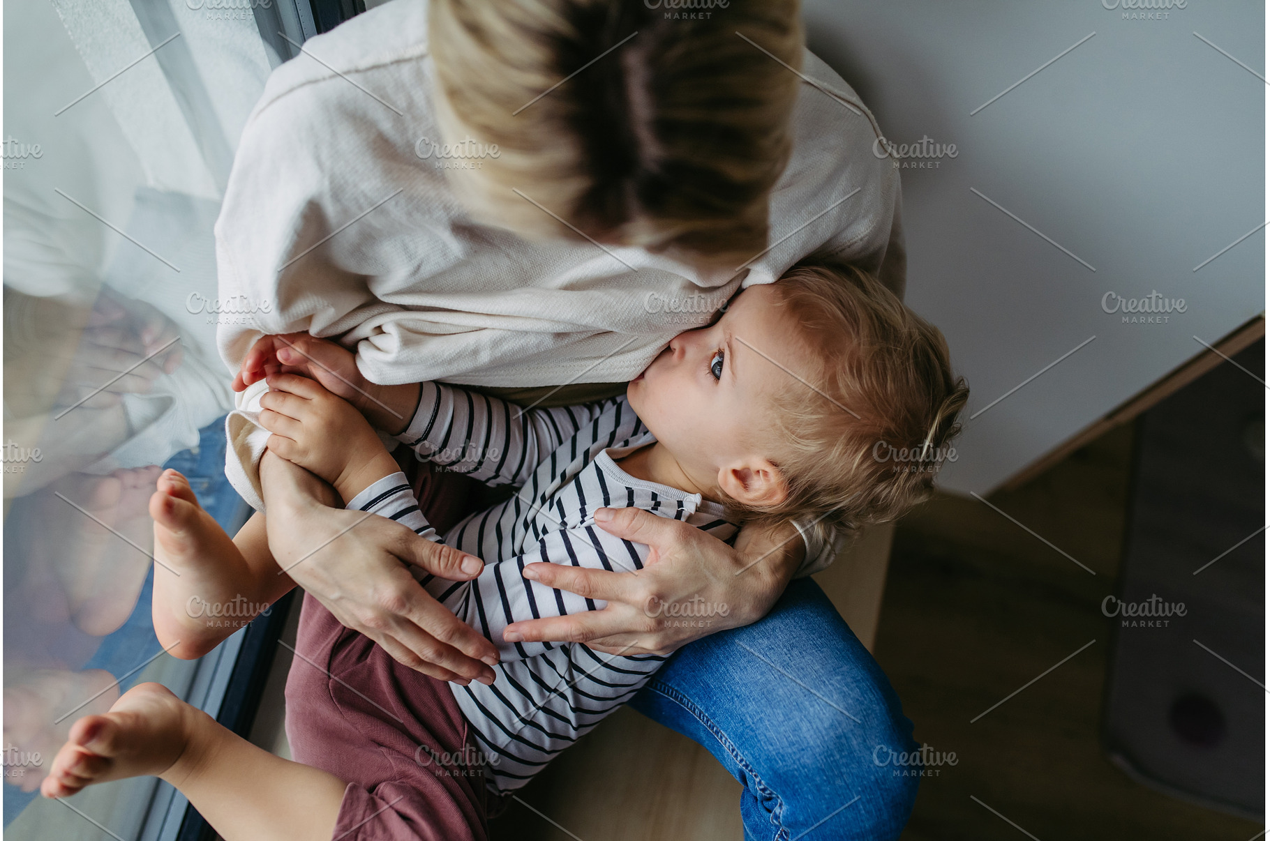 Mother breastfeeding her toddler son, a Person Photo by HalfPoint