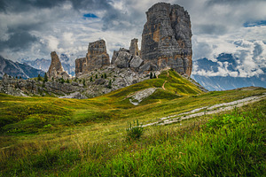 Green meadow and Cinque Torri rocks, a Nature Photo by Alpine Dreams