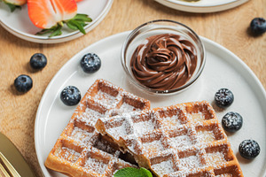 Belgium waffles Homemade waffles with strawberries, a Food & Drink Photo by Budarinphoto