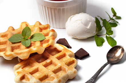 Homemade freshly baked belgian waffles with mascarpone, mint lea