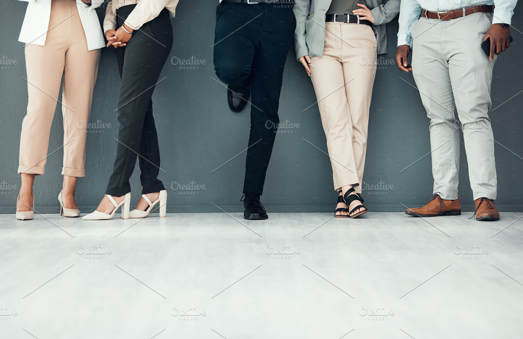 Legs, waiting room and group of people for interview, recruitment or job opportunity on wall background. Shoes, candidates and men with women on mockup for work hiring, process and company startup, a Photo by Peopleimages.com