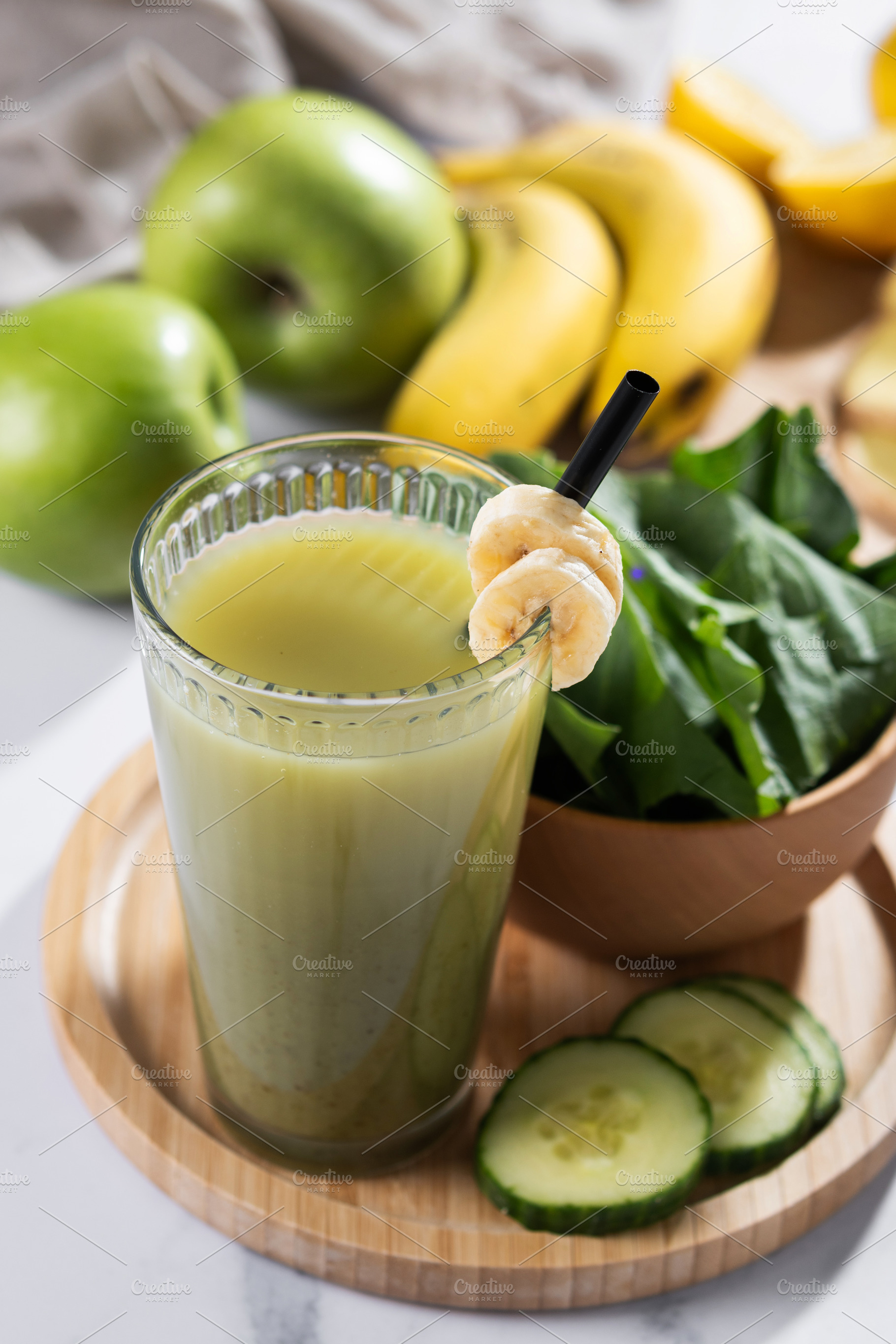 Green smoothie with spinach,banana, apple, and lemon on wooden tablespace, a Food & Drink Photo by etorres69