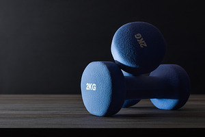Sports concepts with two dumbbells on table with dark background, a Sports & Recreation Photo by Davizro's Market